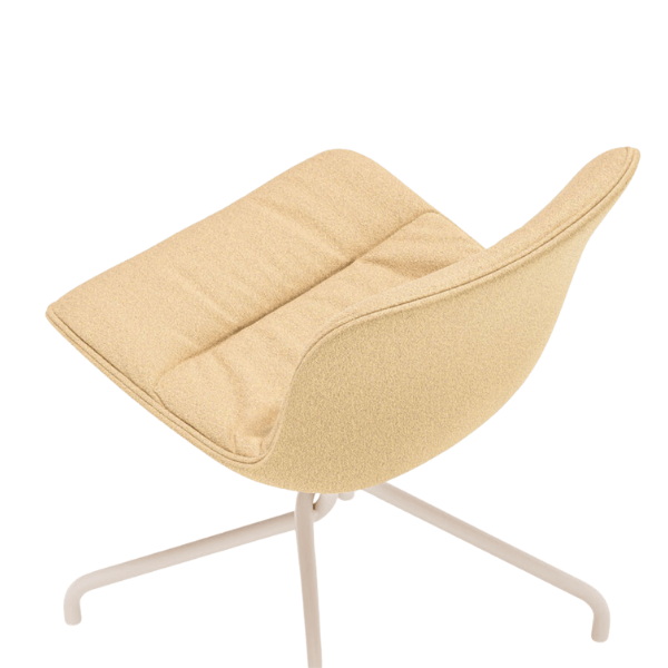 Angled view of a Baltic Soft M Side Chair featuring a cream-colored upholstered seat and slim white metal legs. Modern design.
