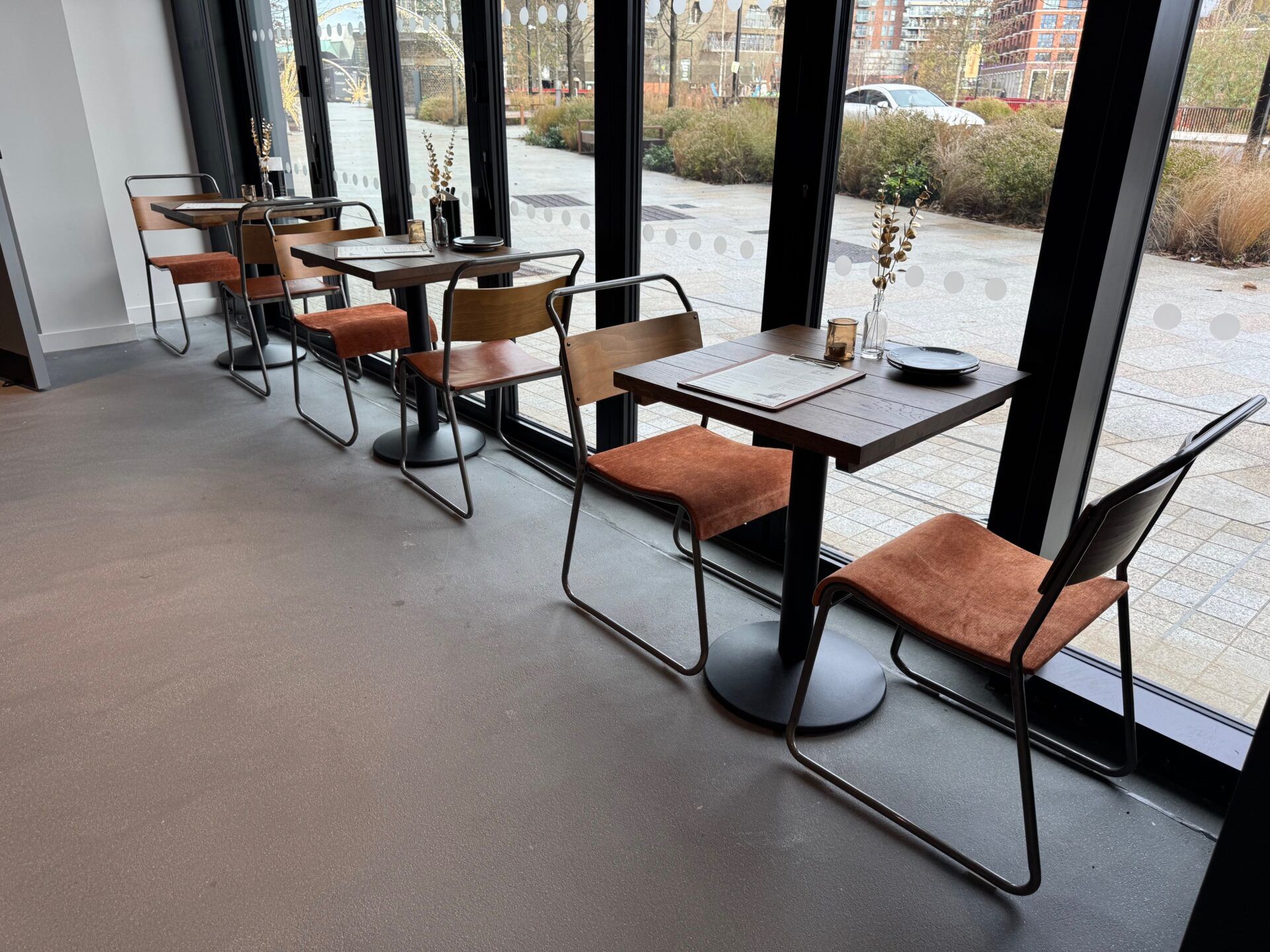 Vagabond Urban Winery London seating area with modern chairs and tables by the window. Interior design project.