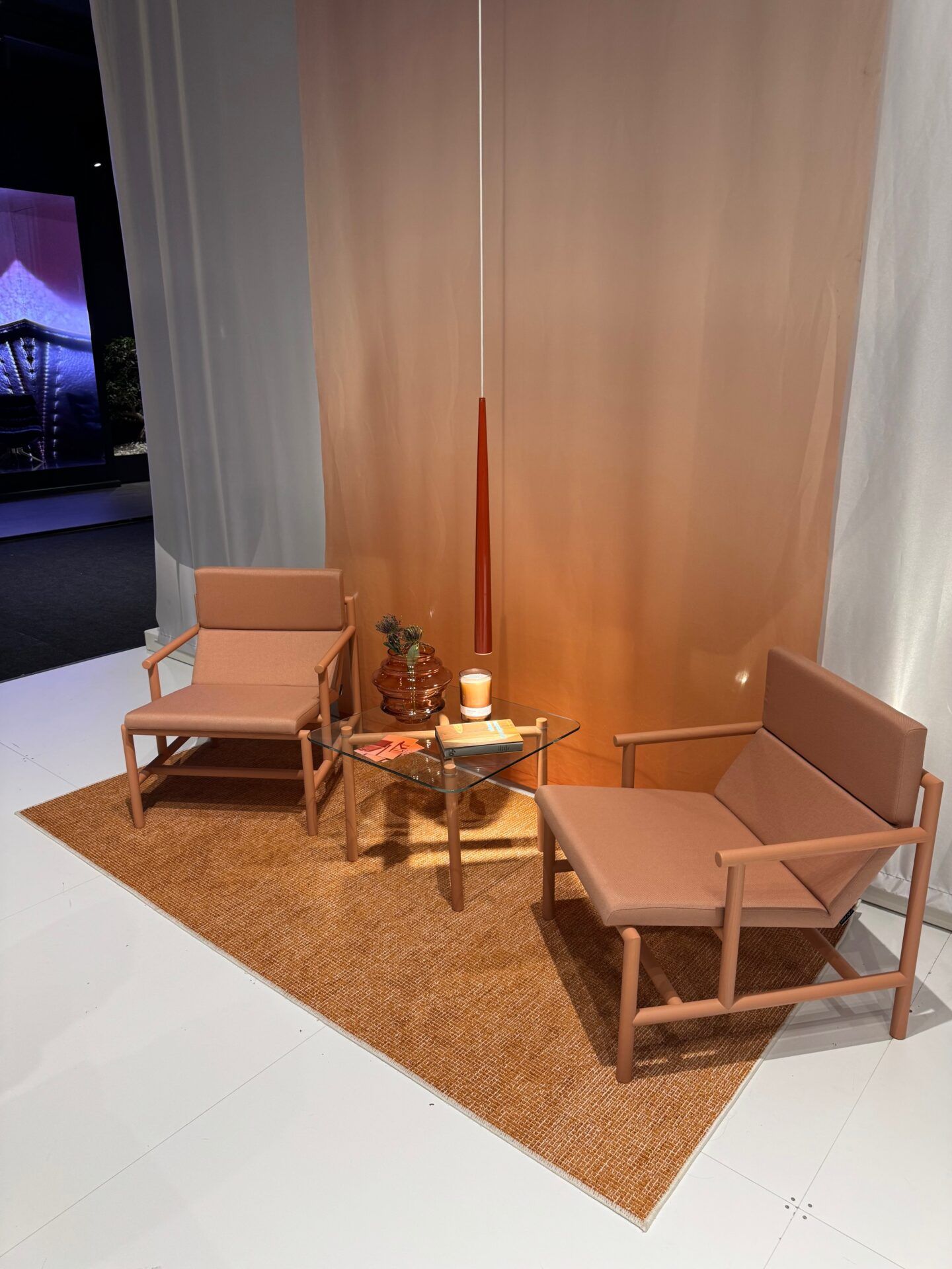 Istanbul Furniture Fair exhibit featuring modern chairs, glass table, and stylish decor; furniture design inspiration.