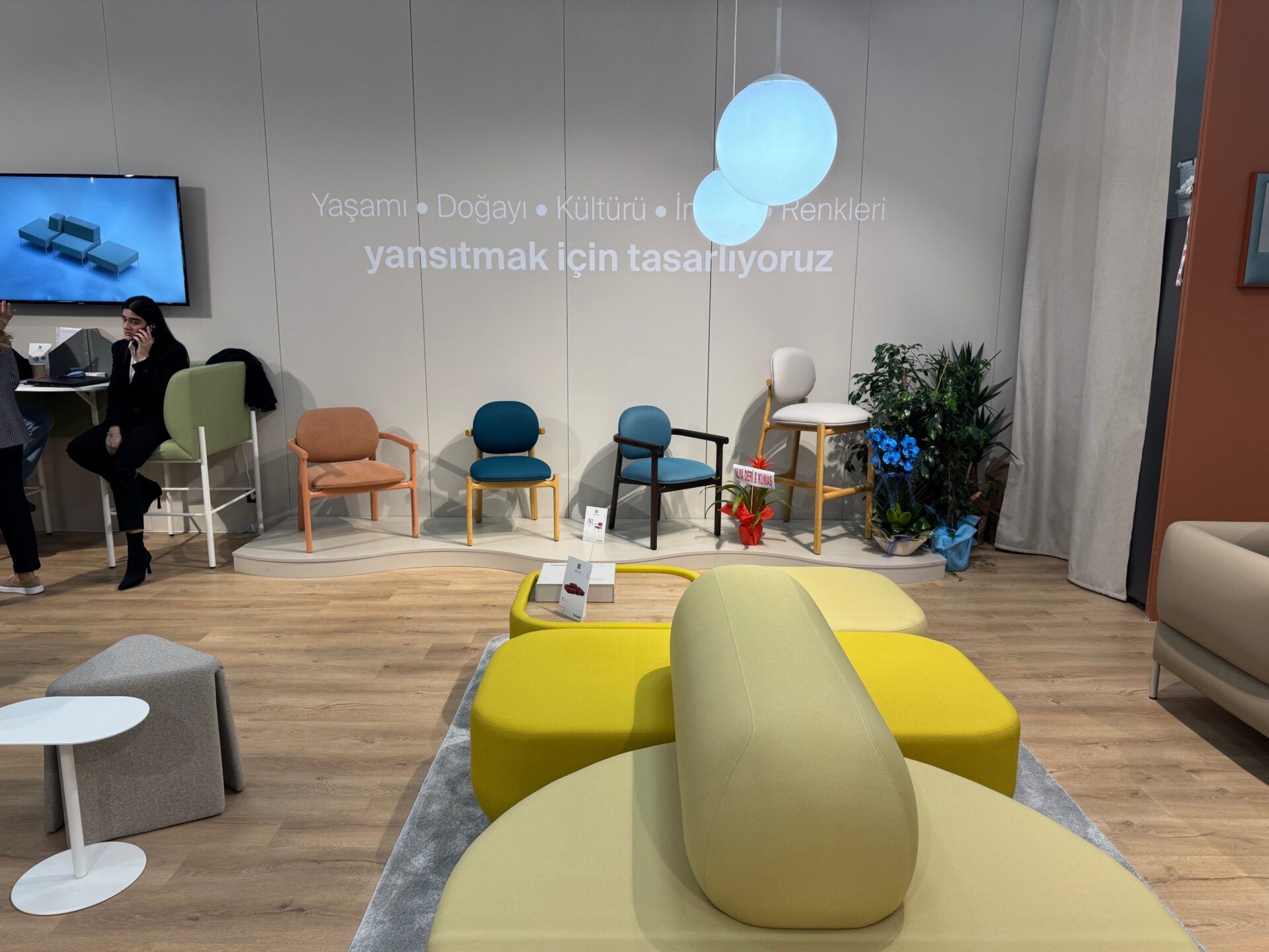 Istanbul Furniture Fair display featuring modern chair designs, colorful seating, and stylish contemporary furniture exhibit.
