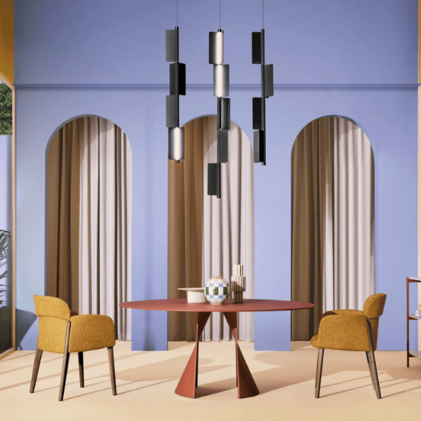 Modern interior featuring a Kawara Floor Lamp with stacked rectangular diffusers, round table, and yellow chairs in a stylish setting.