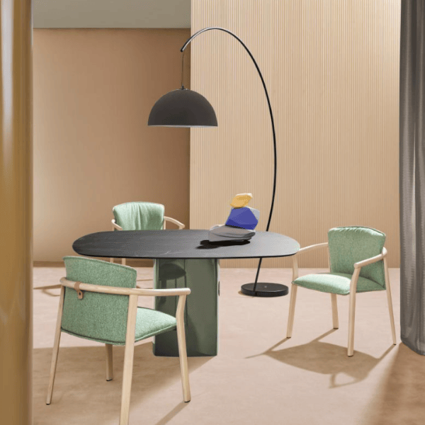 L002ST Floor Lamp with a metal base and black lampshade is featured in a contemporary interior setting with green chairs.