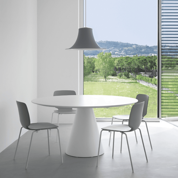 L004CW Pendant Light, gray flared metallic shade, directional lighting above the round table with chairs, modern interior design.