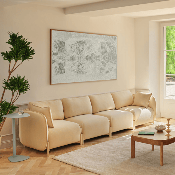 Linka Lounge Chair: Front, eye-level view of the modular sofa, upholstered in a light cream fabric with metal frame accents.