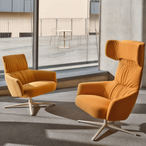 Two Toro Lounge Chairs in orange upholstery with metal base; one high-back, one low-back. Comfortable modern design.