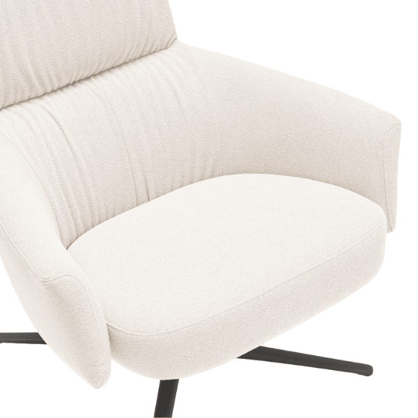 Close-up of a Toro Lounge Chair in cream upholstery with a black metal frame, showcasing its comfortable design.