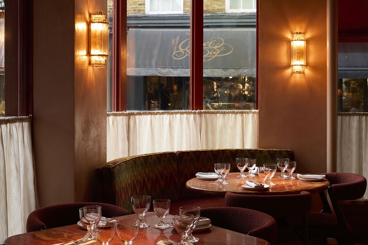 kudu restaurant Kudu Marylebone interior: Stylish dining area with set tables, banquette seating, and ambient lighting for a unique dining experience.