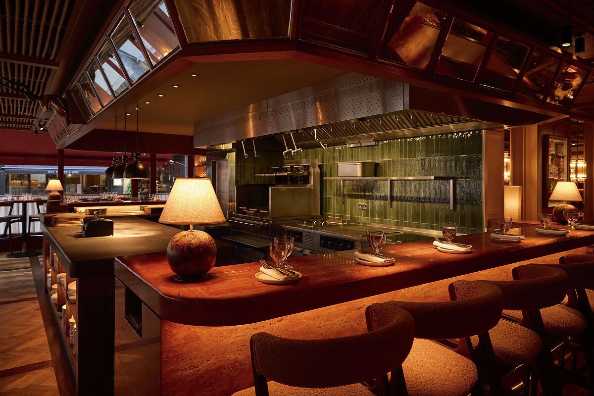 kudu restaurant Kudu Marylebone interior featuring a stylish bar area with cozy seating and a view into the kitchen.