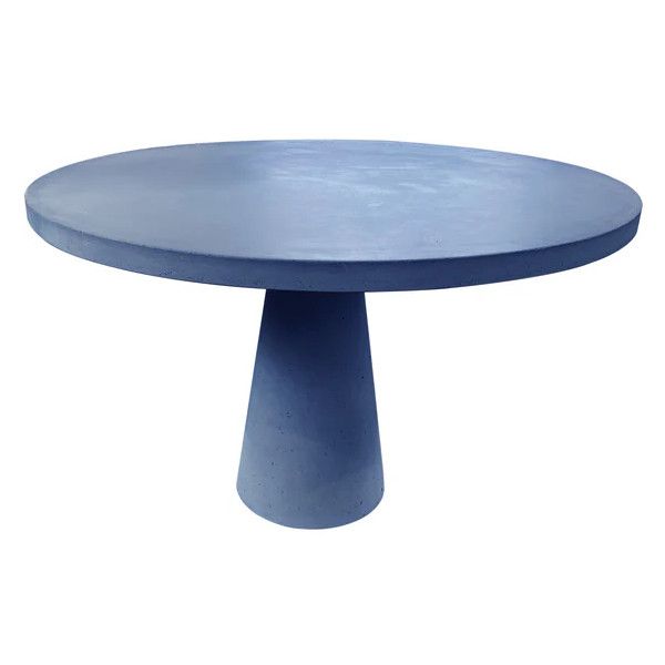 Modern round Concrete Dining Table with a minimalist pedestal base, showcasing its smooth surface and unique texture.