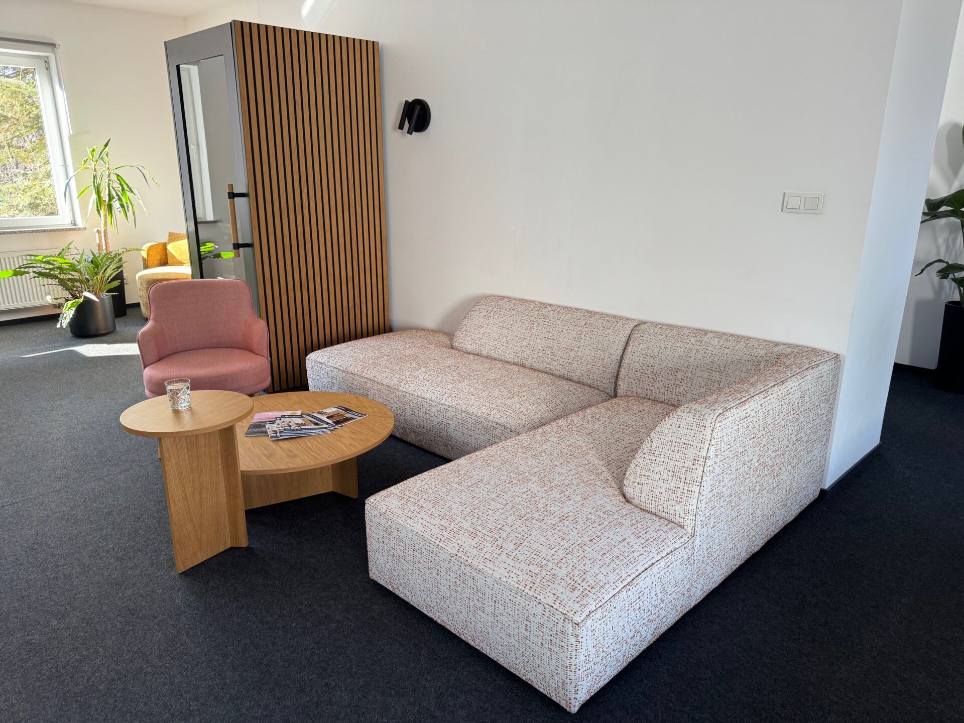 Pueblo sofa Inspiring workplace reception area with contract furniture: stylish sofa, pink chair, wooden tables, and modern design elements, contract furniture.