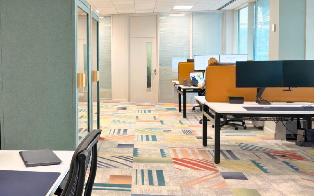 Lumina Learning Global Office interior. Modern office space with colorful carpet, desks, and computer workstations.