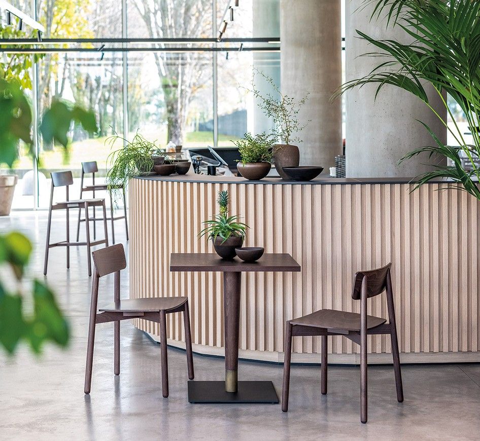 Kaia chairs and tables in modern hotel interior. Hospitality furniture design for restaurants and hotel trends 2026, contract furniture. 