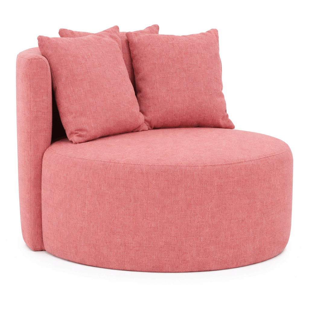 Angled view of the Queens Lounge Chair in a textured pink fabric with two cushions, showcasing its modern, round design.