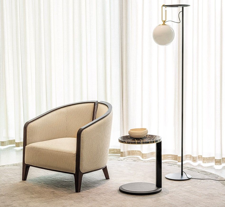 Vida Lounge Chair by hotel furniture suppliers. Hospitality interior design featuring modern chair, side table and floor lamp.