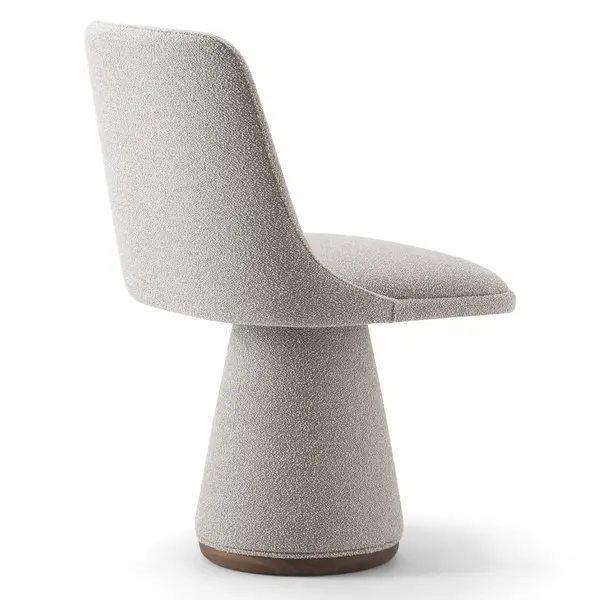 Side view of the Flo Side Chair featuring light gray upholstery, a curved backrest, and a unique pedestal base with wood trim.