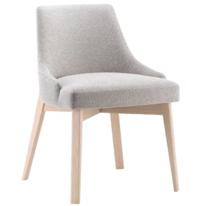 Angled view of Kora Side Chair, upholstered in light gray fabric with light wood frame, ideal for commercial lounge furniture.