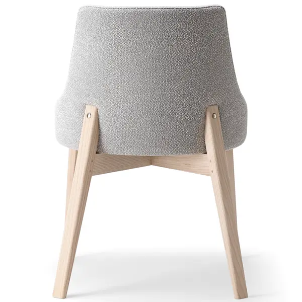 Rear view of Kora Side Chair featuring light gray upholstery and light wood frame construction.