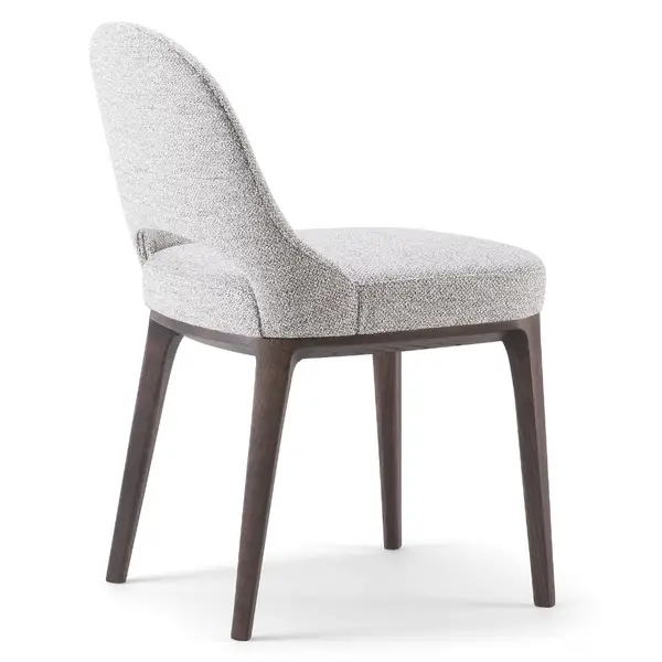 Side view of a Lea T Side Chair with light gray textured upholstery and dark wood frame and legs on a white background.