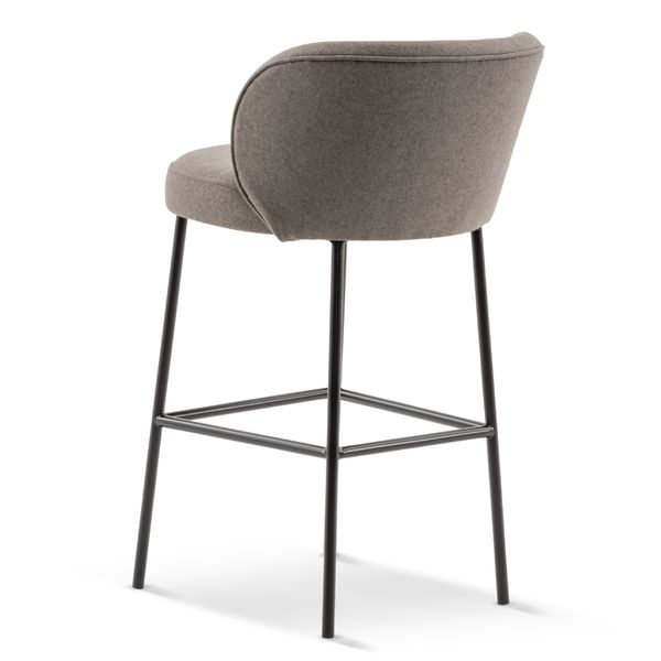 Rear view of a gray upholstered Luna Barstool with slim black metal legs and footrest, showcasing its modern design.