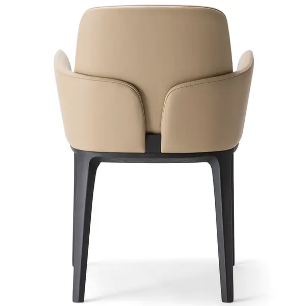 Rear view of Mila T Armchair: beige upholstered seat and back with wood frame, showcasing its sculptural back detail.