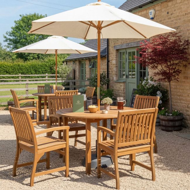 Outdoor setting featuring the Hardy Armchair in a natural wood finish, arranged around a round table with parasols, perfect for patios.