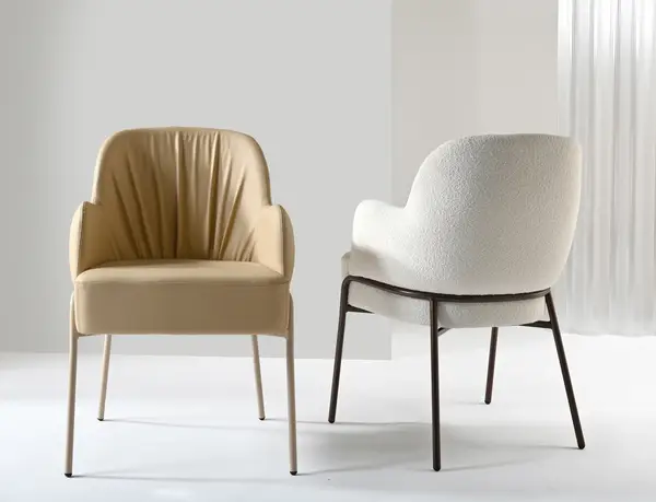 Modern Adele Armchairs: One in tan leather with metal frame, the other in white bouclé with black metal frame.