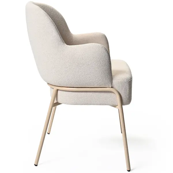 Side view of the Adele Armchair featuring a cream boucle upholstered seat and back, with a metal frame and legs.