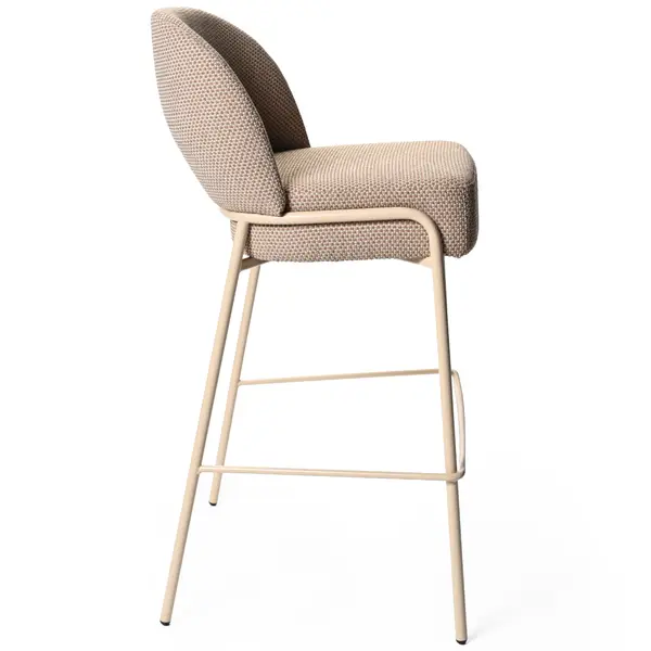 Side view of the Adele Barstool featuring a beige upholstered seat and back with a slim, light-colored metal frame.