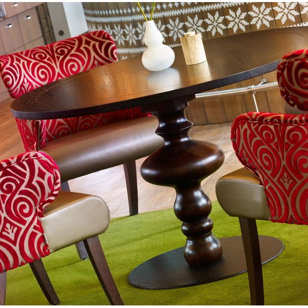 Eye-level shot of Marie Round Dining Table displays its elegant solid oak frame, distinctive turned leg, and smooth, refined wood top.