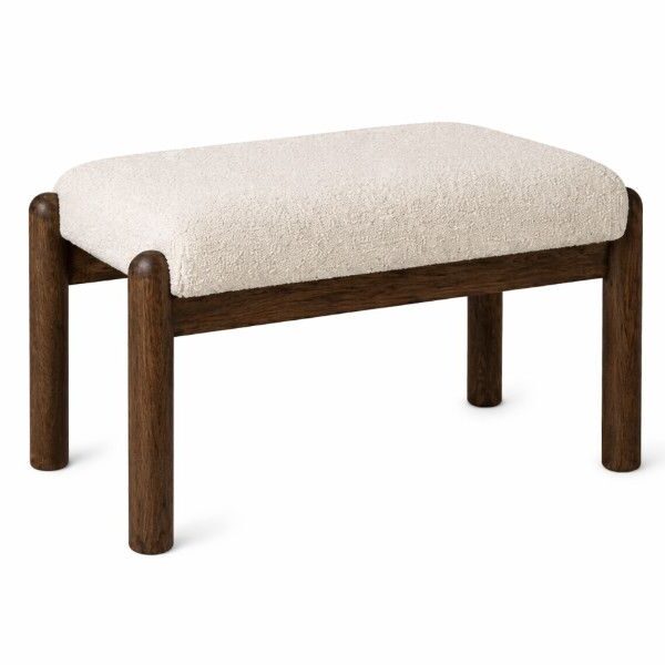 Angled view of the Selene Low Stool, featuring a cream upholstered seat and dark brown wooden frame and legs.