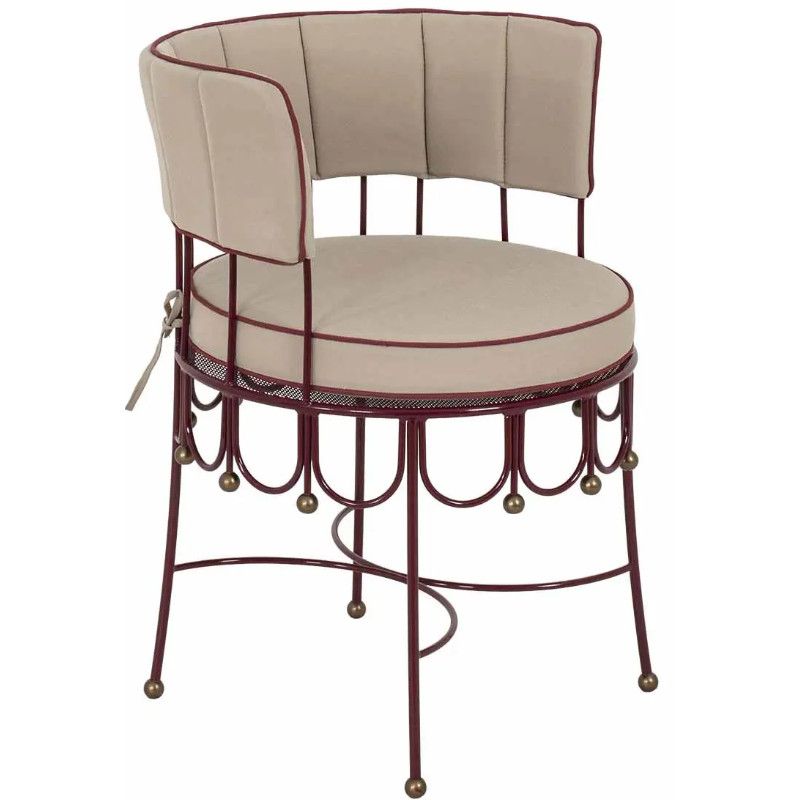 Three-quarter angle of the Maroon Armchair highlighting its deep burgundy metal frame and cushioned beige upholstery.