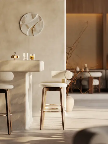 Auro Barstool with cream seat and timber frame positioned beside a modern stone counter in a warm, minimalist interior.