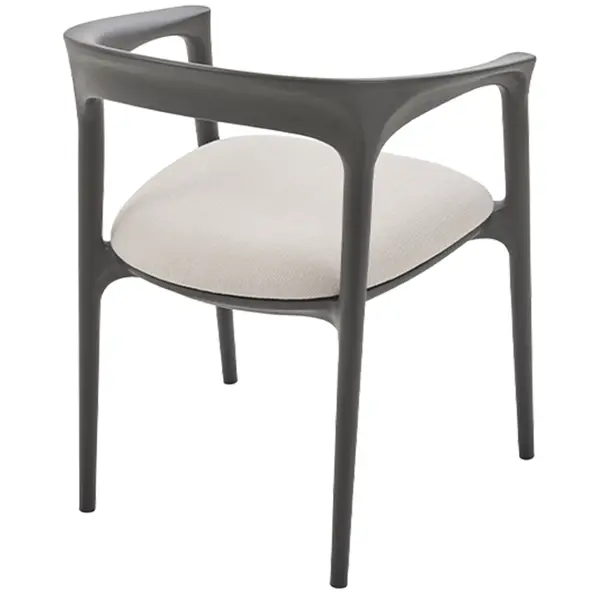 Single Fau Armchair showcasing its flowing black timber frame and neutral padded seat in a studio product shot.