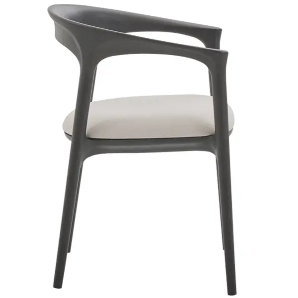Profile view of a Fau Armchair highlighting its curved black wooden frame and smooth, light-toned upholstered seat.