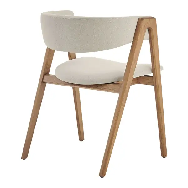 Rear view of the Gala Armchair, featuring a curved timber frame and cream-colored upholstered seat on a white background.