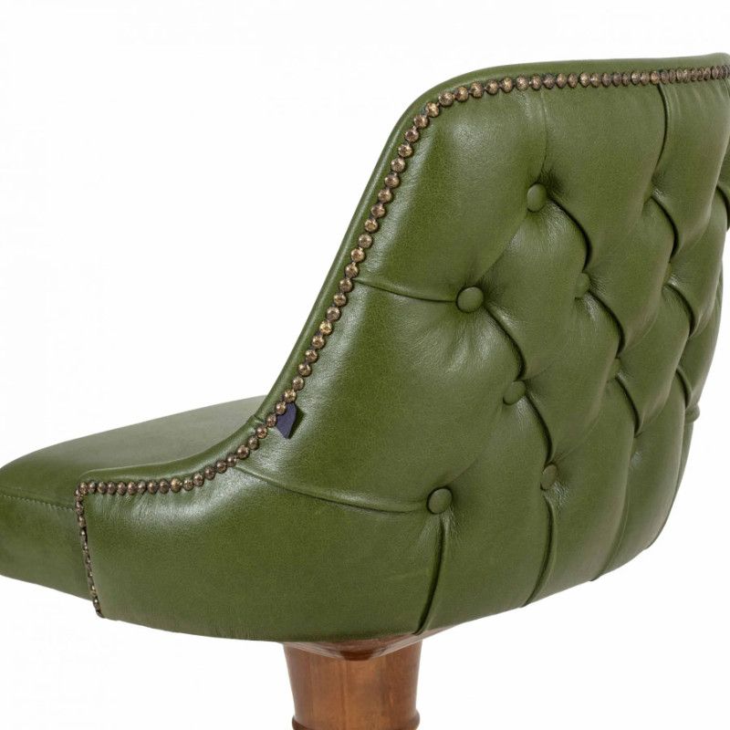 Close-up of the Mungo Barstool back, showing button-tufted sage green leather and metallic trim on a wooden frame.