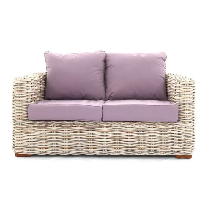 tula sofa Tula sofa featuring a light wicker frame with mauve upholstered cushions, shown from a front-facing studio angle.