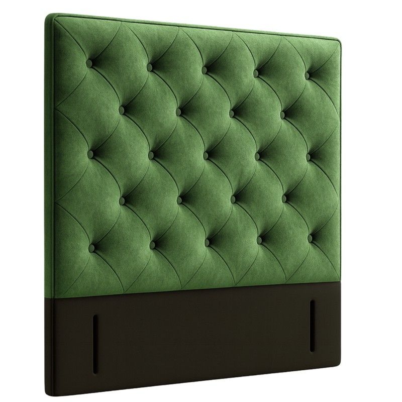 Angled view of a Chester double headboard featuring plush forest green upholstery with deep button tufting details.