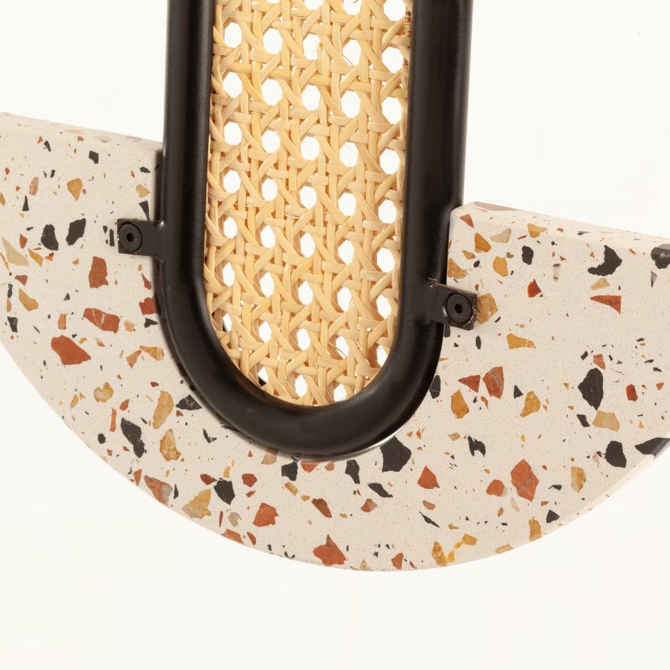 Close-up of Frame Medium Pendant Light showing the black metal connection between the woven rattan and terrazzo stone.