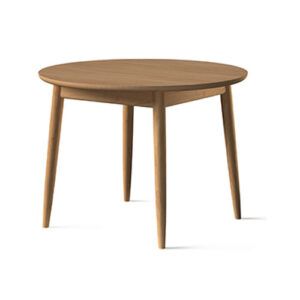 Toscano dining table in light wood with a round top and tapered four-legged base, shown from a side angle.