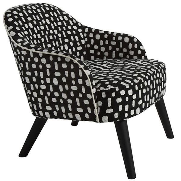 Carmen lounge chair with black and white patterned upholstery, curved back, white piping, and dark tapered wooden legs.