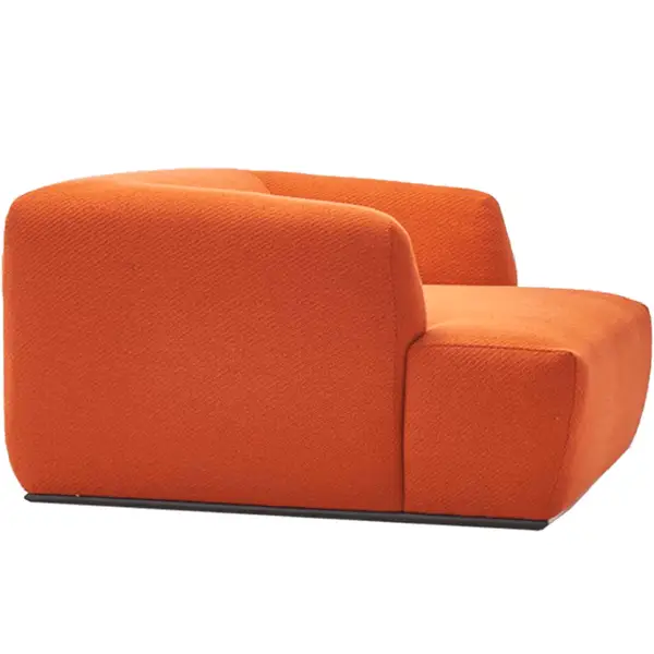 Side angle of the orange Loop Lounge Chair showing its smooth, curved silhouette and solid, low-profile base.