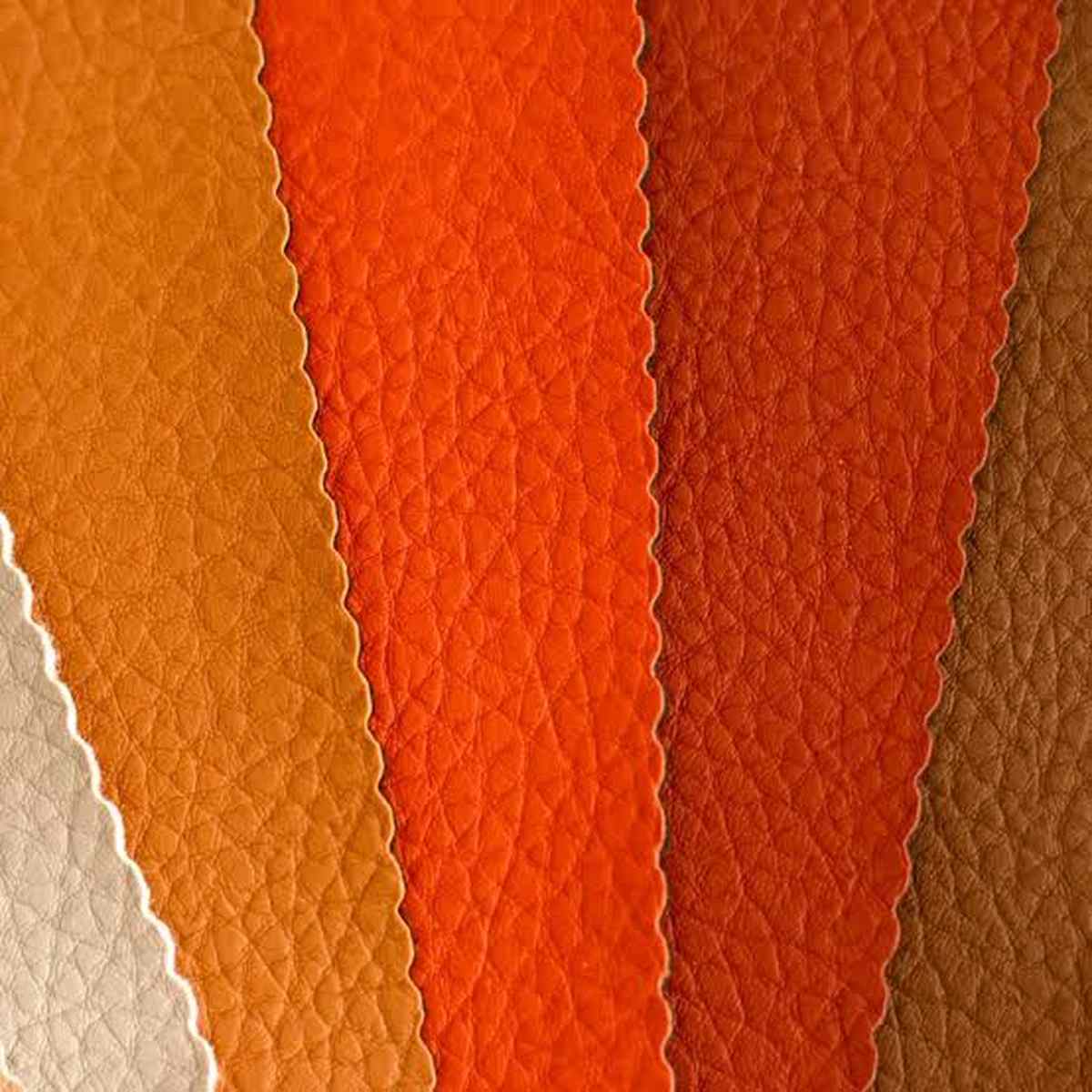 faux-leather Swatches of faux leather in gradient shades of cream, amber, orange, terracotta, and brown with scalloped edges.