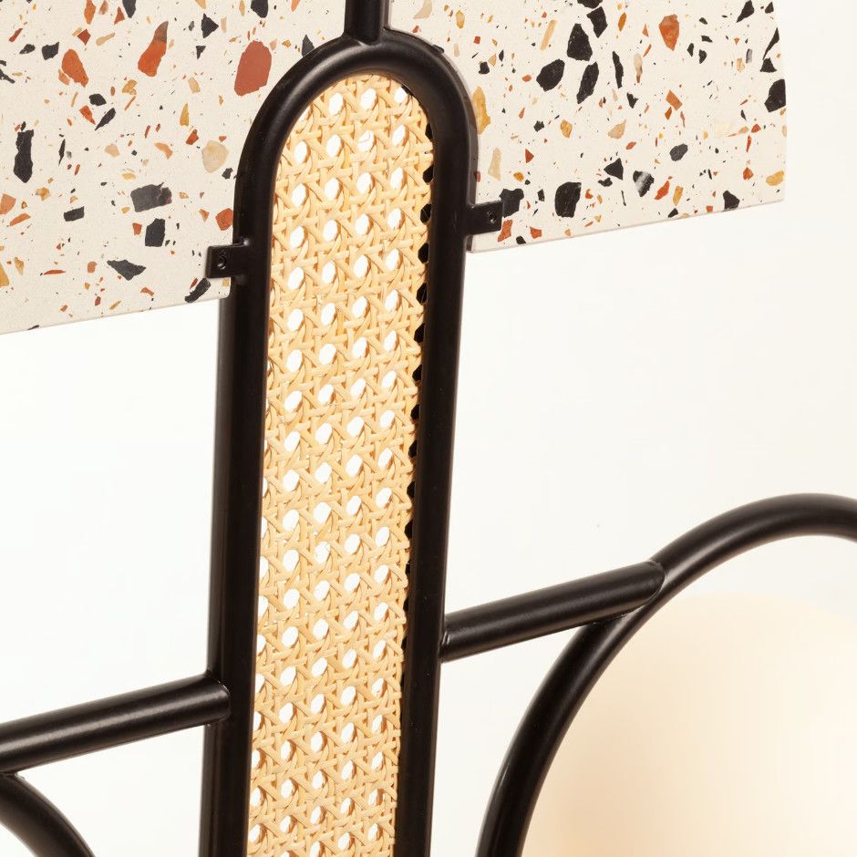 Close-up of Frame Large Pendant Light showing black metal structure with woven cane insert and patterned terrazzo shade.