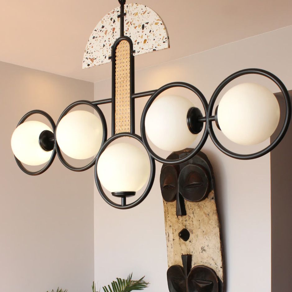 Frame Large Pendant Light featuring circular black frames, opal globe lamps, woven accents, and a semicircular top detail.