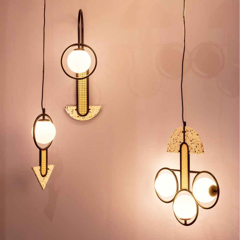 Three Frame Medium Pendant Lights displayed together, showing various terrazzo shapes, rattan panels, and glowing orbs.