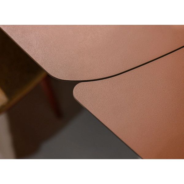 Close-up detail of the Leo Extendable Dining Table showing the seamless join and smooth warm-toned veneer tabletop edges.