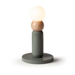 Play I Table Lamp with a sage green lacquered base, natural oak wood detail, and a glowing white frosted glass orb.