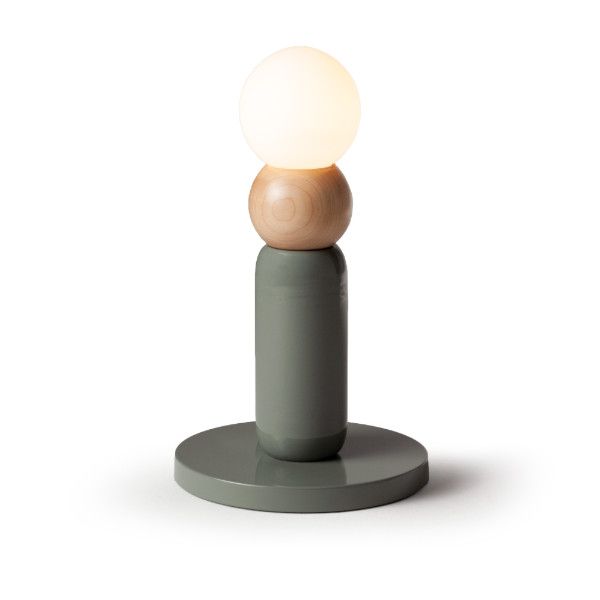 Play I Table Lamp with a sage green lacquered base, natural oak wood detail, and a glowing white frosted glass orb.