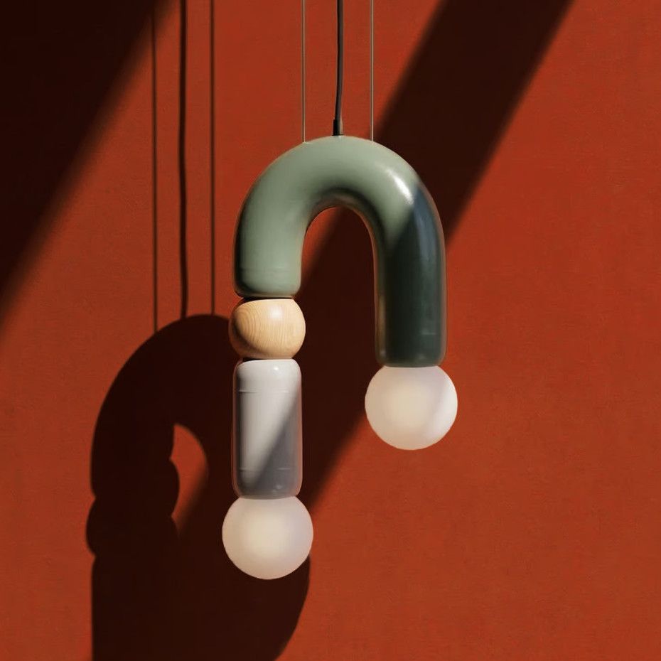 Play II pendant light featuring a U-shaped olive metal frame, natural oak detail, and dual frosted globes against red.